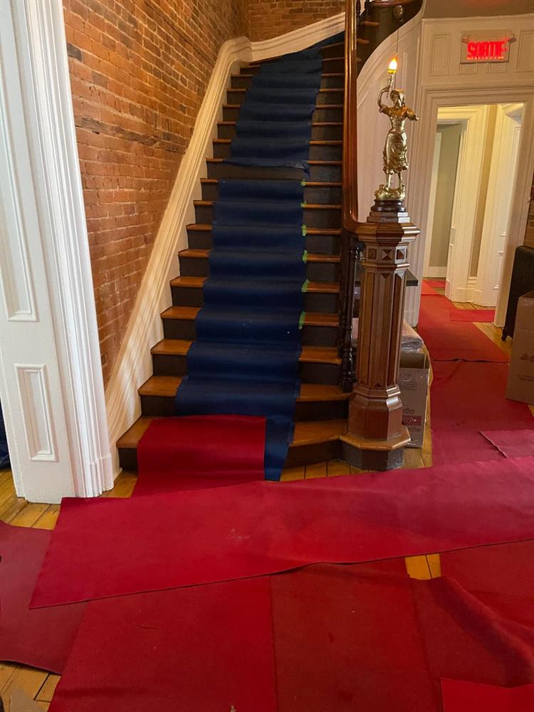 Wooden staircase protected with a runner along its full length