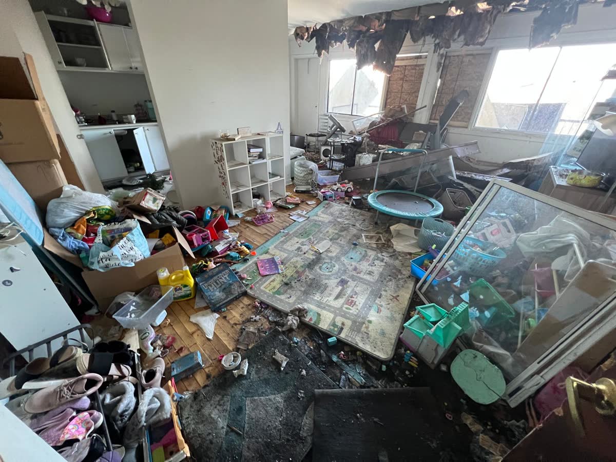 Salon d'un logement encombré du sol au plafond, avant le débarras